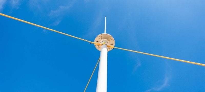 Looking up at a radar device mounted on a pole.