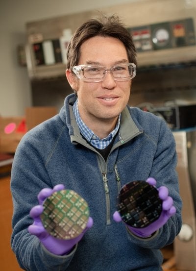 Person holding two solar cells.