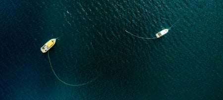 Michigan Techâ€™s research vessel Agassiz floats at anchor beside a NOAA GLERL research vessel.