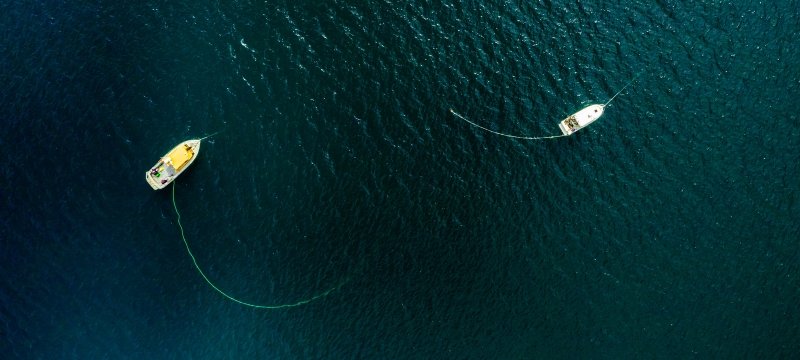 Overhead view of two boats on the water.