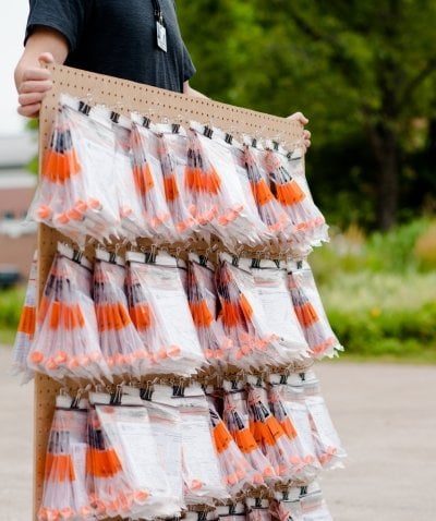 Peg board full of COVID testing vials in bags.