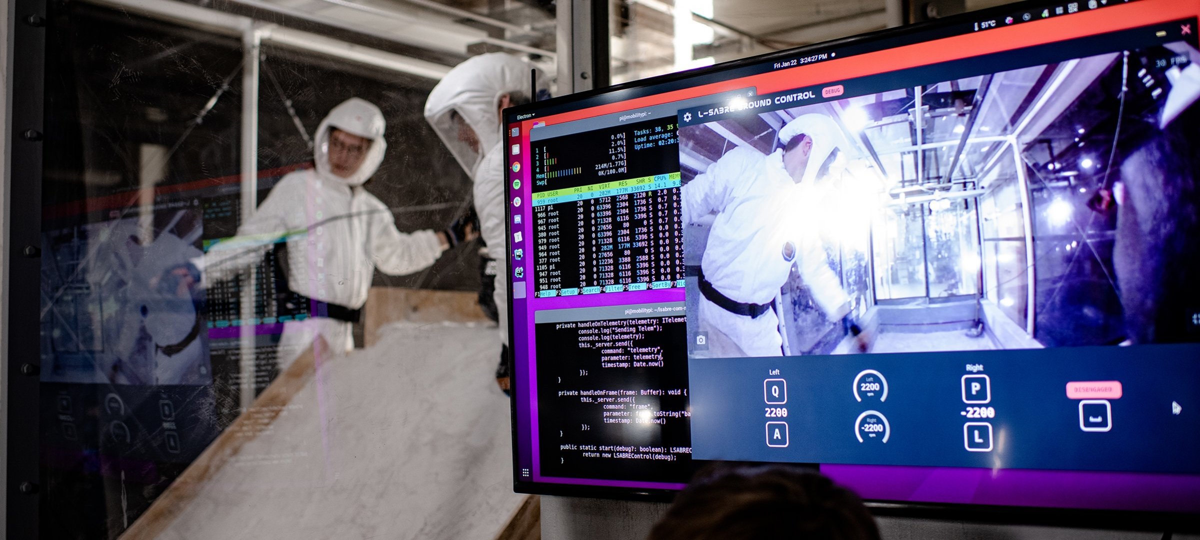 Researchers working in the PSTDL lab and a view of them on a computer screen.