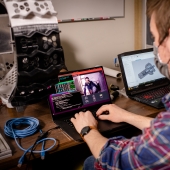 Researcher working on a laptop in the lab.