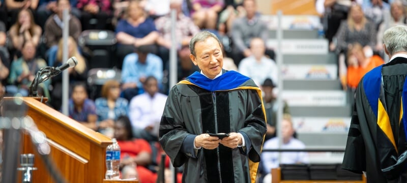 Chang Park walking from the podium with his silver medal award at the 2024 commencement.
