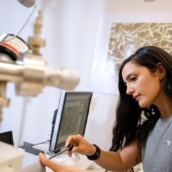 Using an electron microscope.