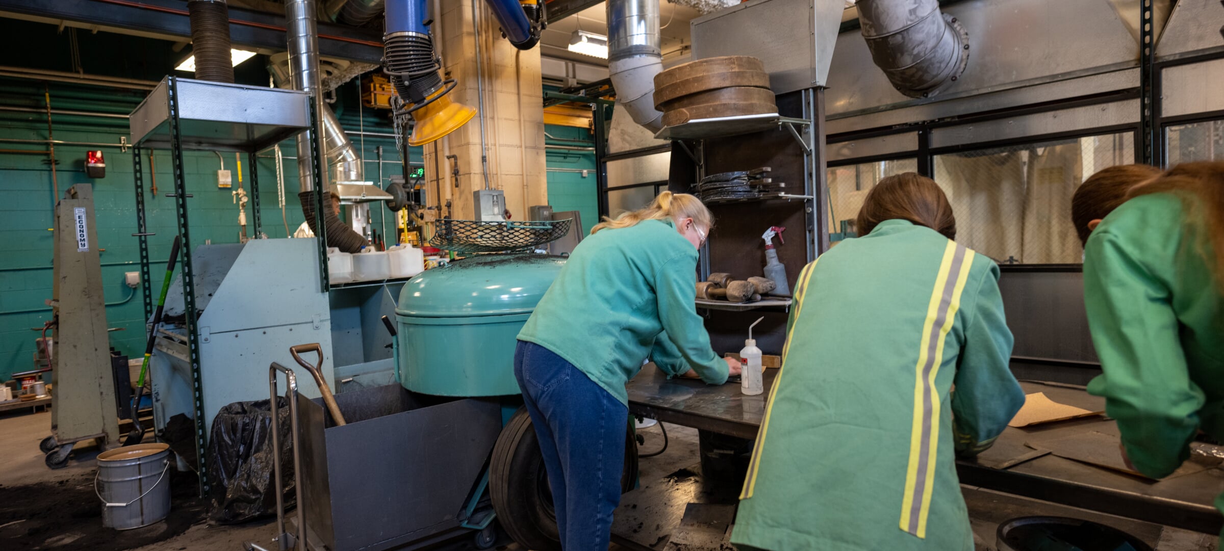 Grad students working with metal