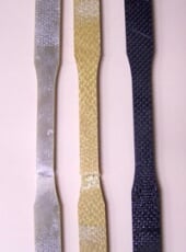 Three narrow sections of materials with different appearances.