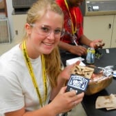 A teenager showing off something they made