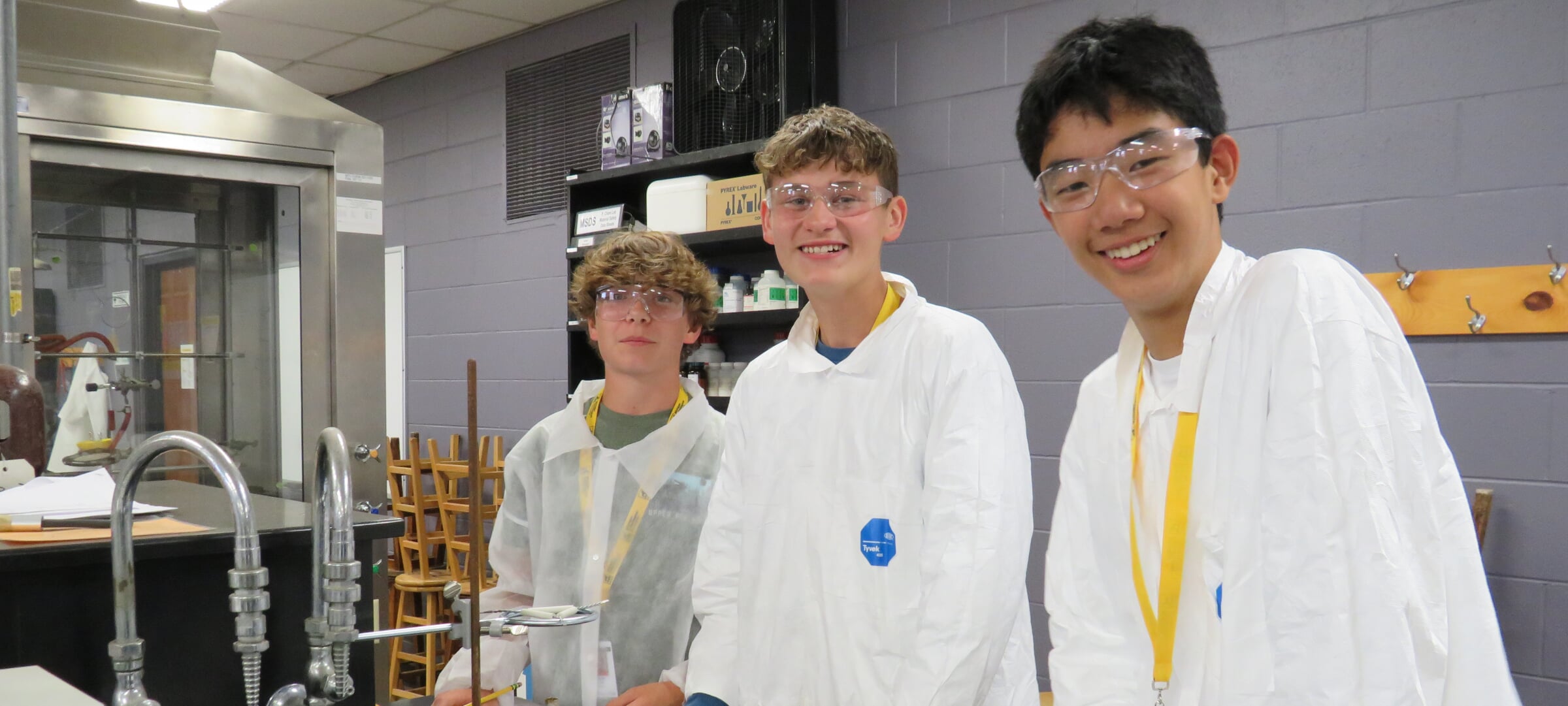 Three teenagers in a group for a picture