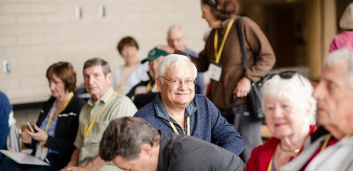 Sitting man smiling at table