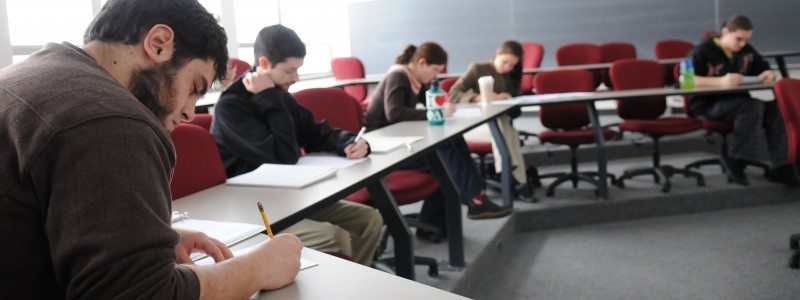 Students in a classroom taking an exam