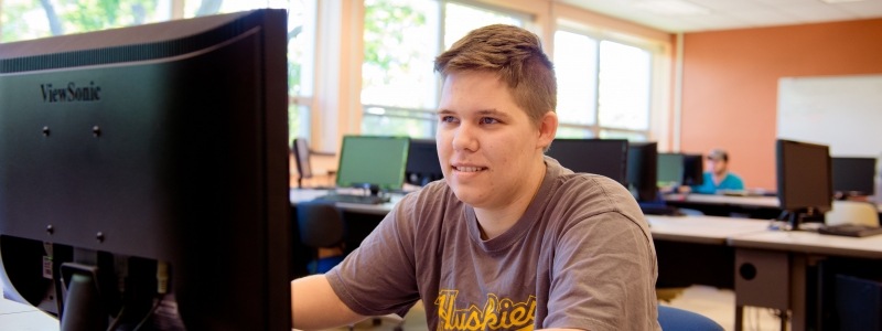 Student working through online math course in computer lab