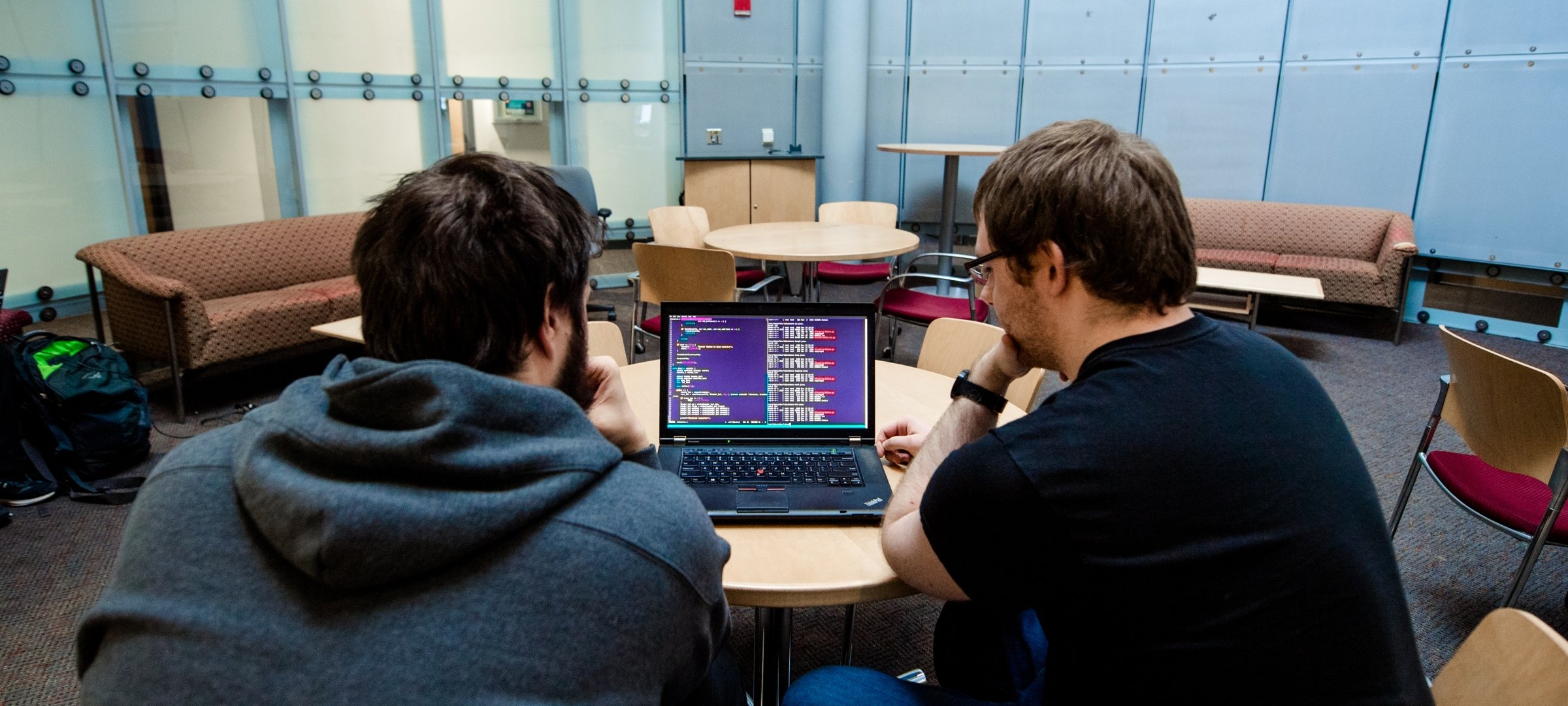 Two students working at a laptop.