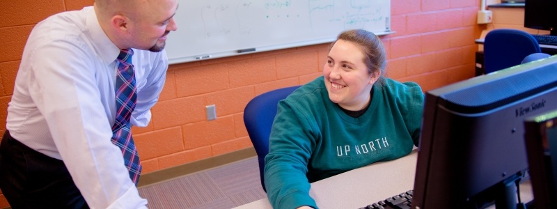 Faculty working with a grad student