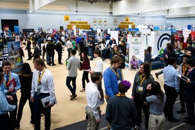 Michigan Tech students in business attire visit recruiters at display tables