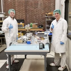 Students assembling components in a clean room