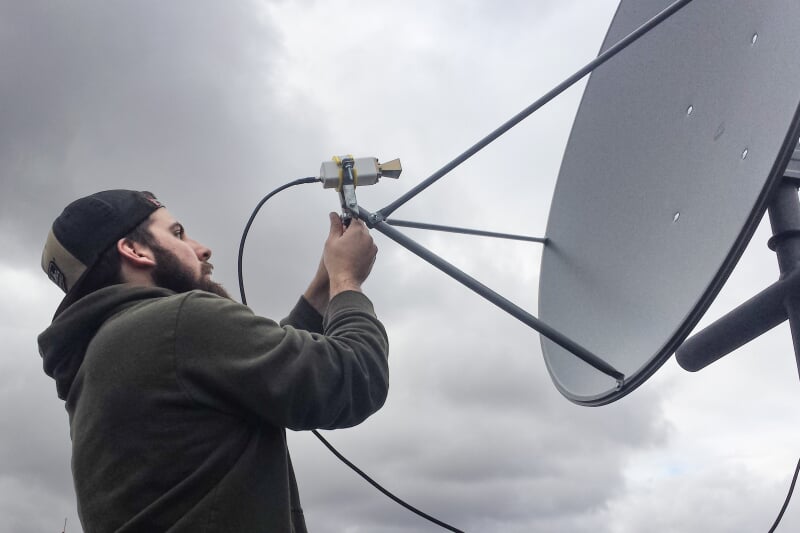 A student positioning an Auris ground station