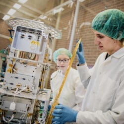 Two students working on an Oculus structural assembly