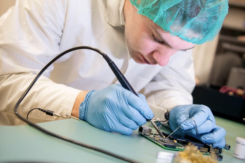 Student soldering a Stratus test board