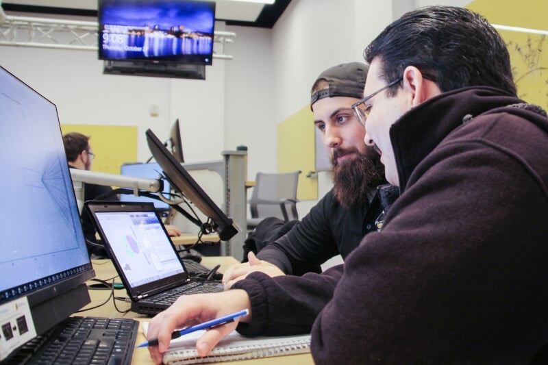 Two students working on a computing project