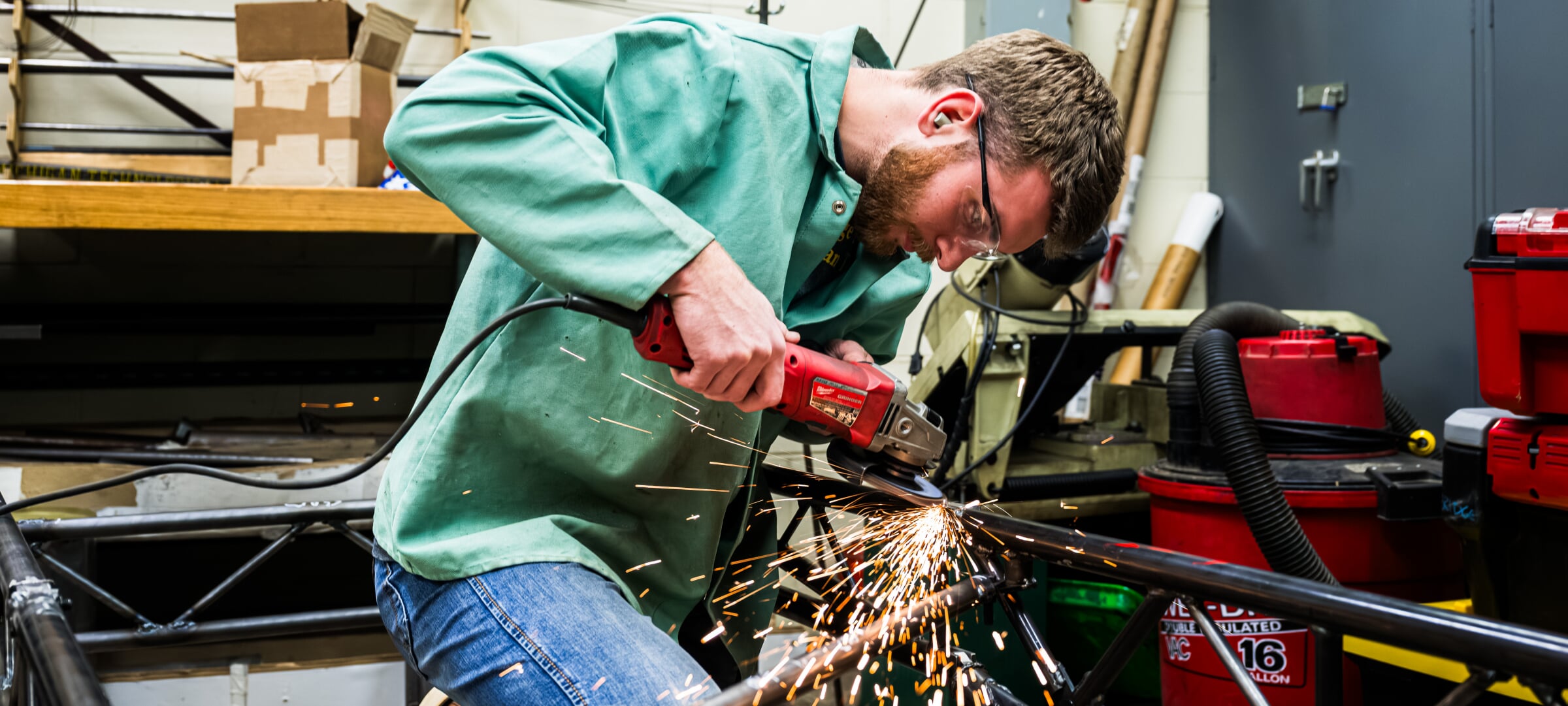 Students using a grinder on metal
