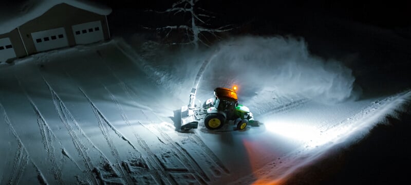 Aerial view of the snowblower at work in a driveway.