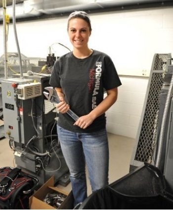 student in the lab smiling