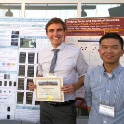 Yongchao Yang and student in front of posters.