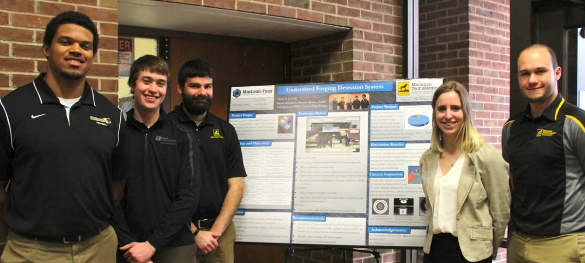Five students stand by their project poster.