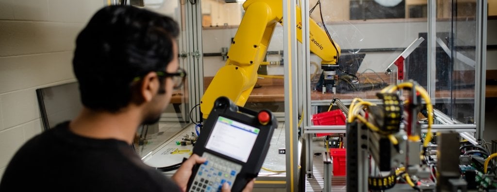 Student using robotics equipment in the lab.