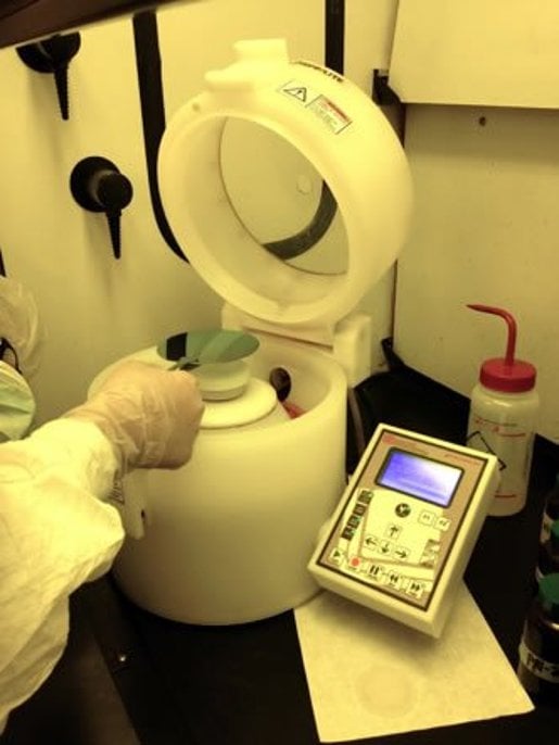 Laurell Spinner, researcher placing a sample inside