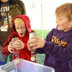 Students doing an experiement with bottles and eggs.