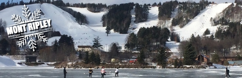 Hockey players on the frozen canal in front of Mont Ripley.