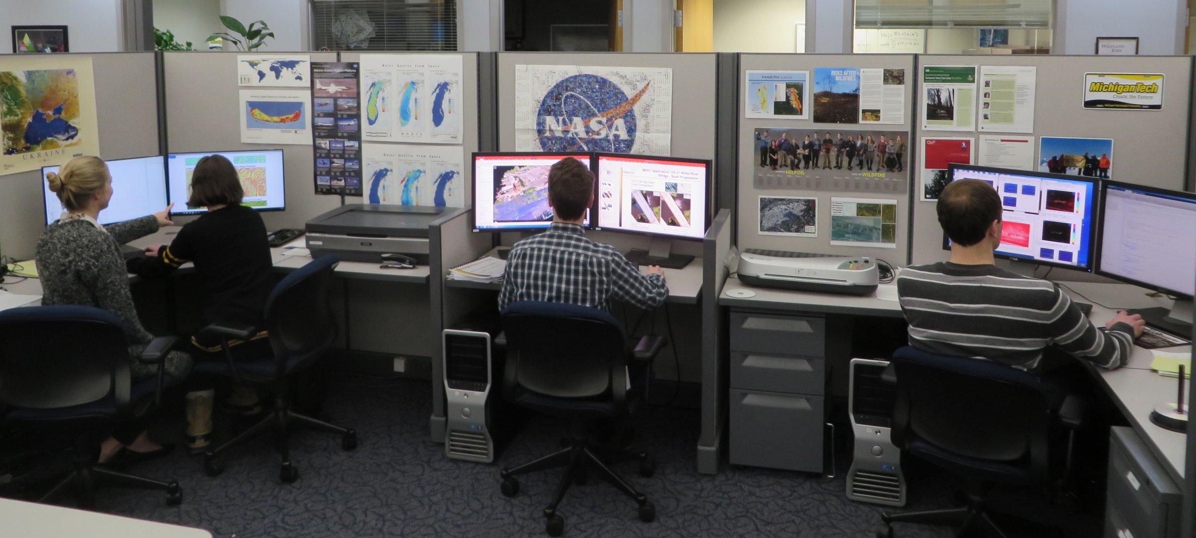 People sitting at computer stations.