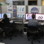 People sitting at computer stations.