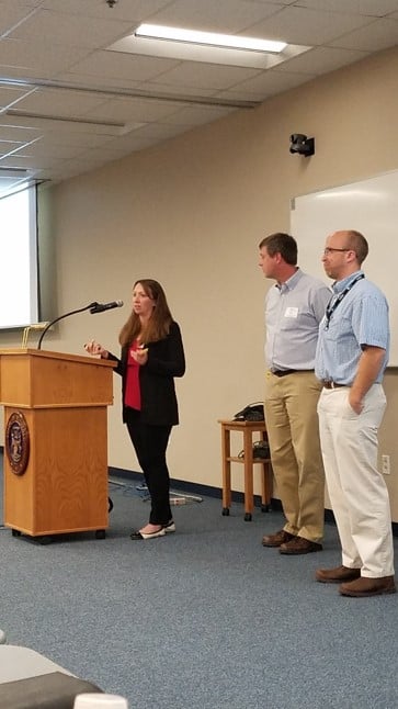 People presenting at a podium.