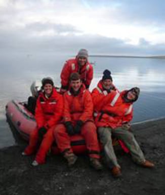 Five people sitting on a motor boat.