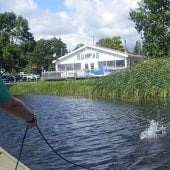 Rake tool tossed into the water from a boat.