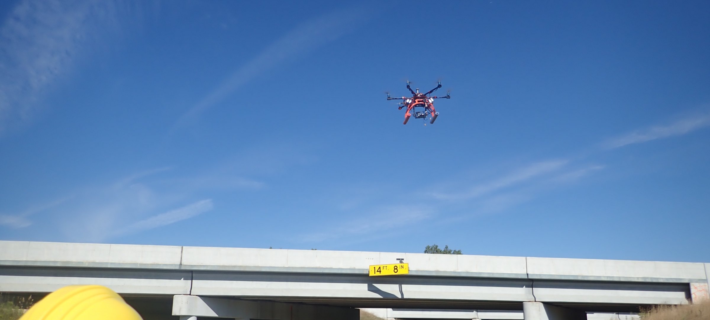 Hexcopter flying above a bridge.