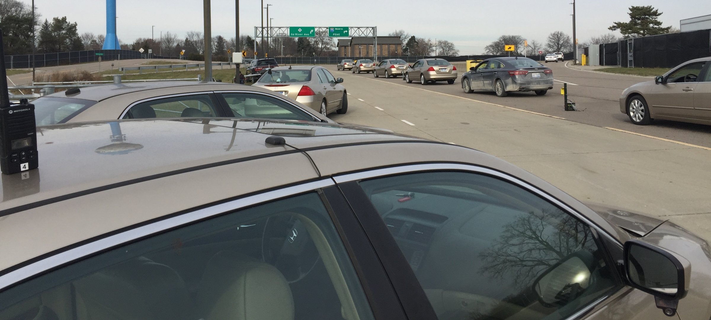 Cars lined up on an on-ramp.