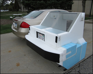 Test vehicle back end next to a regular car.