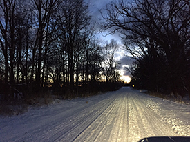 Snowy road at night.