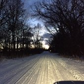 Snowy road at night.