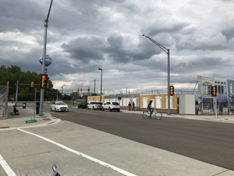 Intersection with a few cars and pedestrians.