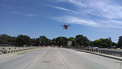 Hexacopter flying over a bridge.
