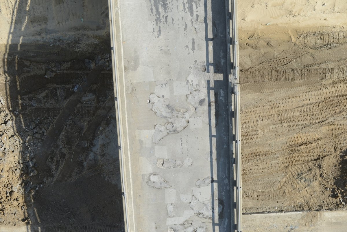 Aerial view of a damaged bridge deck.