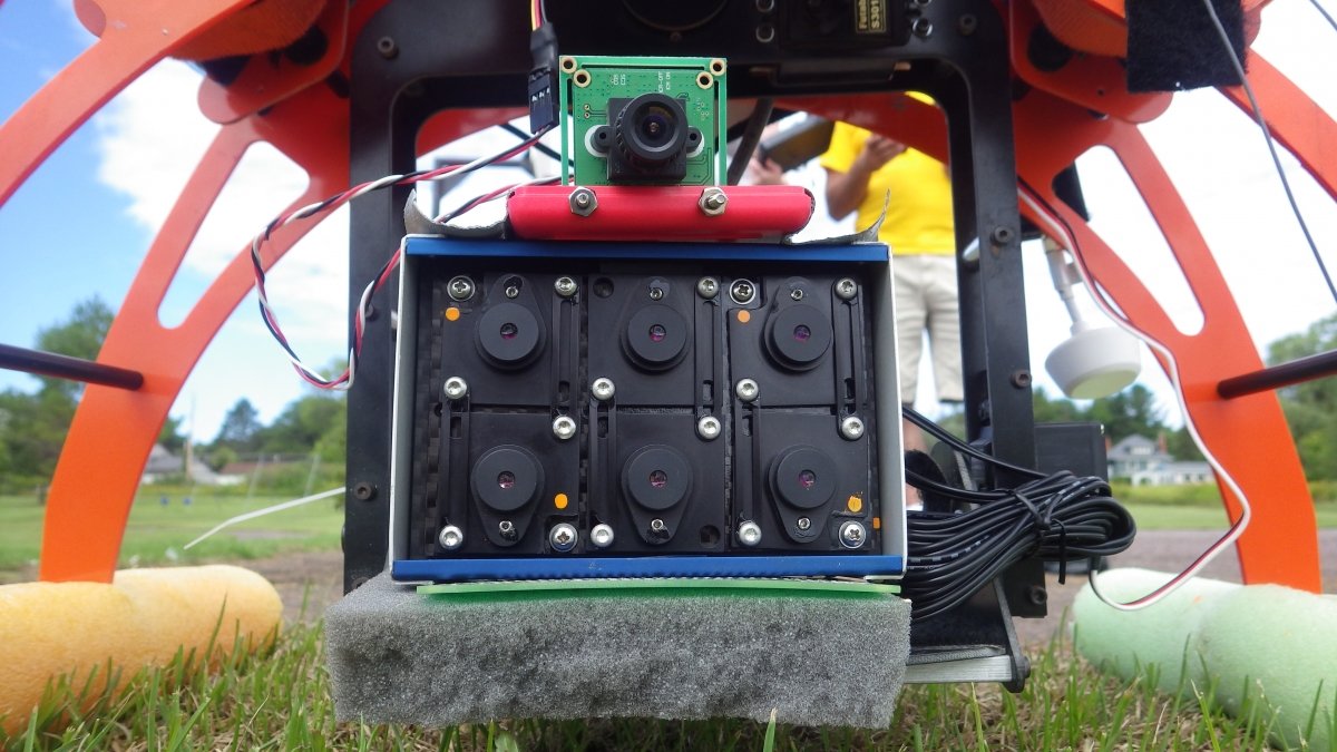 Tetracam mounted on the bottom of a quadcopter.