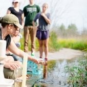 Ecosystem Science Center showing people in the field gathering water samples.