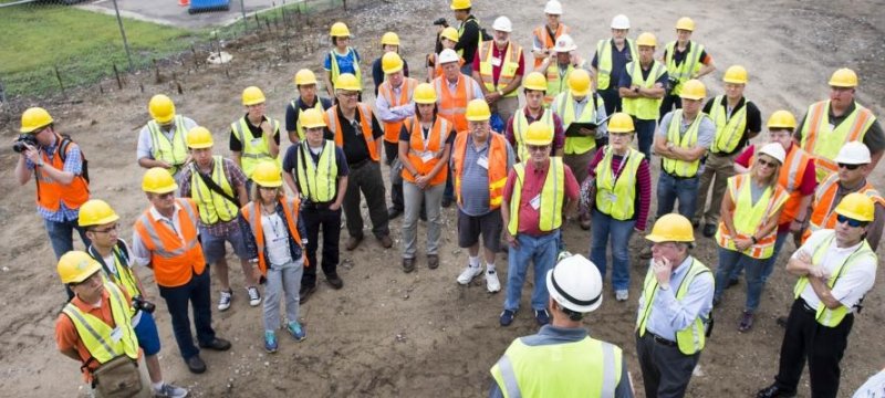 Field visit showing a large group of people wearing outside wearing gear.