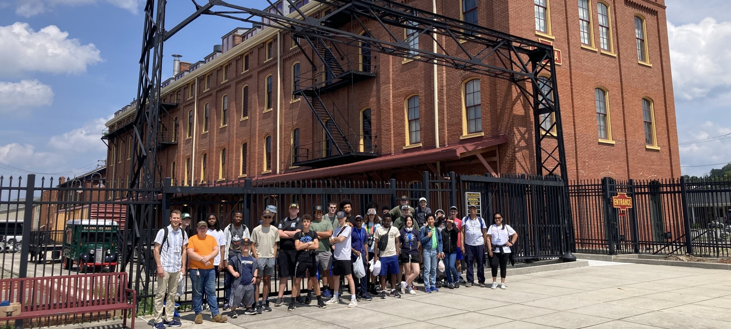 Large group of diverse students outside a railroad museum